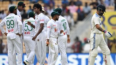 Hasan Mahmud reveals why he didn't celebrate after dismissing Virat Kohli, Rohit Sharma, says 'if I celebrate after taking wickets, it will...' India's Virat Kohli (R) walks back to the pavilion after his dismissal as Bangladesh's players celebrate during the first day of the first Test in Chennai on September 19. (Getty)