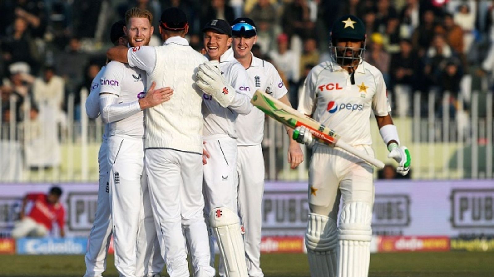 PCB's financial concerns rise as Pakistan vs England Test series media rights remain unsold Ben Stokes celebrates with teammate after taking Babar Azam's wicket (getty)