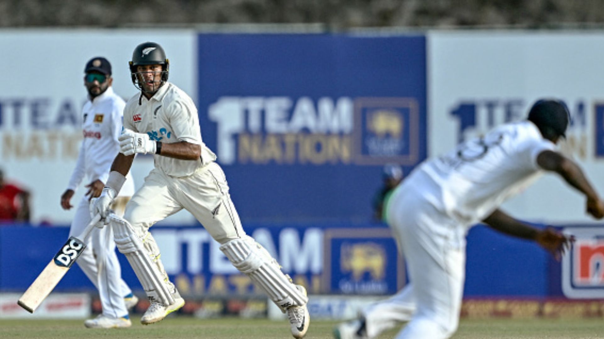 SL vs NZ: Rachin Ravindra stands between Sri Lanka and win with adamant 91 as Galle Test poised on thrilling juncture New Zealand's Rachin Ravindra (C) runs between the wickets during the fourth day of the first Test against Sri Lanka at the Galle International Cricket Stadium in Galle on September 22. (Getty)