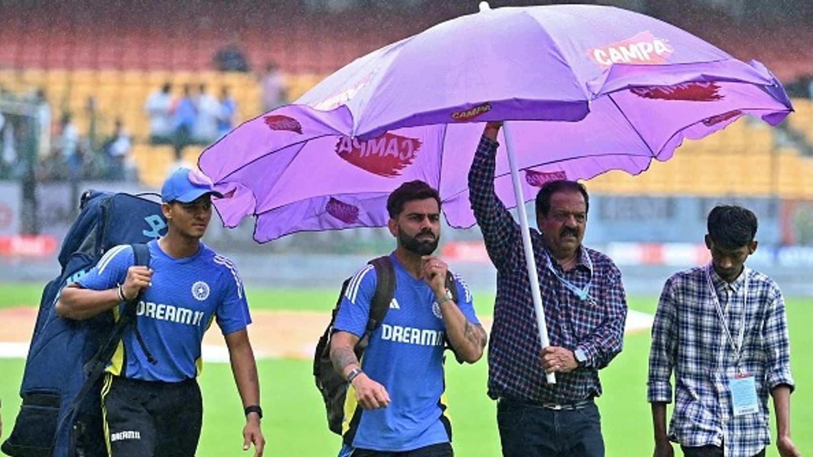 IND vs NZ: Incessant rain causes washout on Day 1 of first Test in Bengaluru, gives Shubman Gill another day to recover India's Virat Kohli (2L) and Yashasvi Jaiswal (L) walk across the field as it rains before the start of the first day play of the first Test cricket match between India and New Zealand at the M. Chinnaswamy Stadium in Bengaluru on October 16