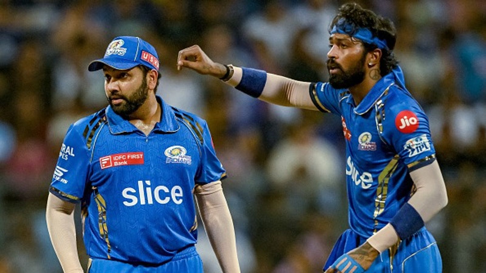 EXPLAINED: Why Rohit Sharma agreed to take the lowest salary among Mumbai Indians' top four picks in IPL 2025 retention? Know here Mumbai Indians' captain Hardik Pandya (R) gestures as Rohit Sharma looks on in this frame