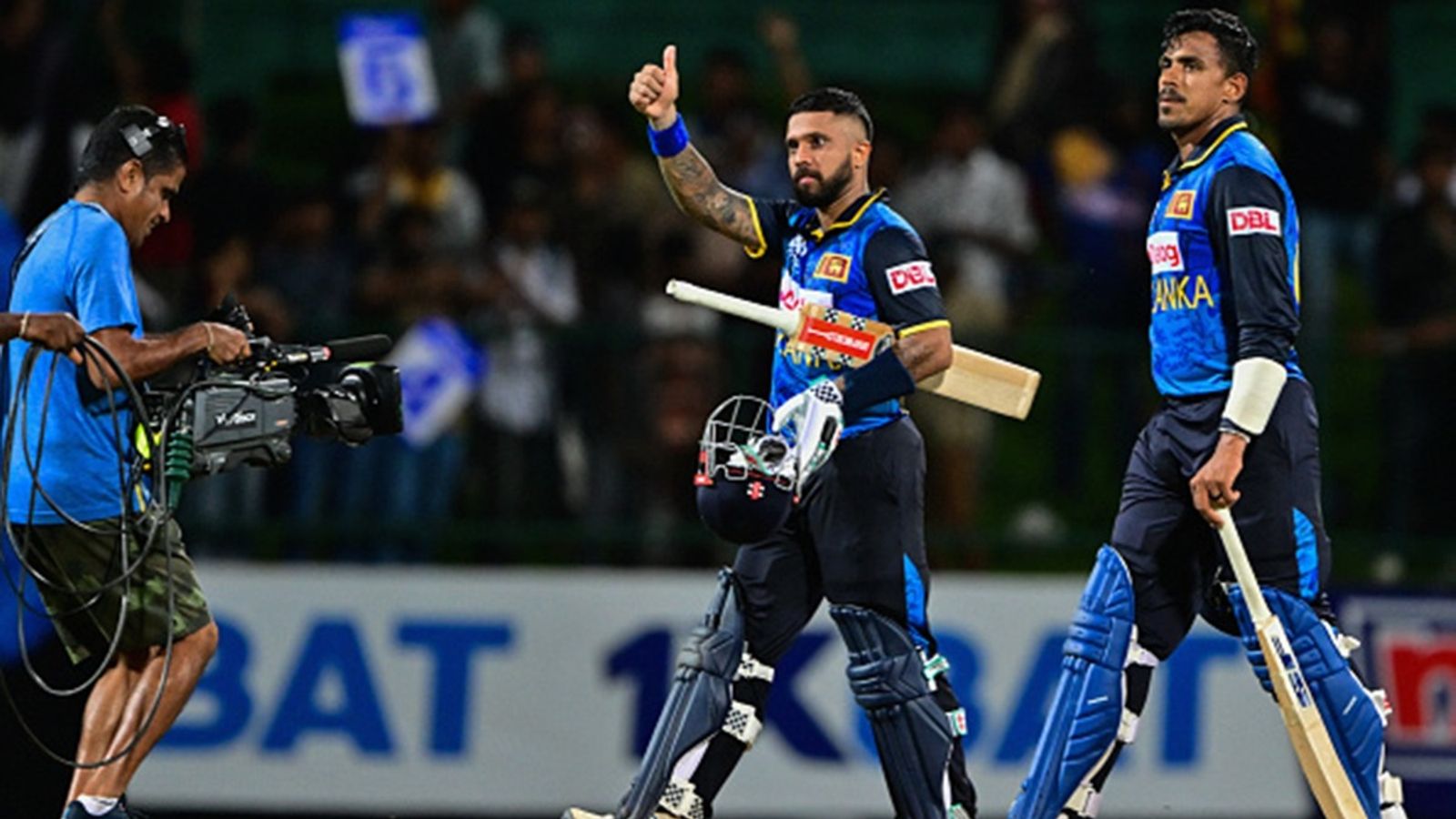 SL vs NZ: Kusal Mendis' record-breaking knock leads Sri Lanka to 3-wicket win in low-scoring encounter, clinch series Sri Lanka's Kusal Mendis (C) and Maheesh Theekshana (R) celebrate their team's victory by 3 wickets at the end of the second ODI against New Zealand at the Pallekele International Cricket Stadium in Kandy on November 17, 2024.