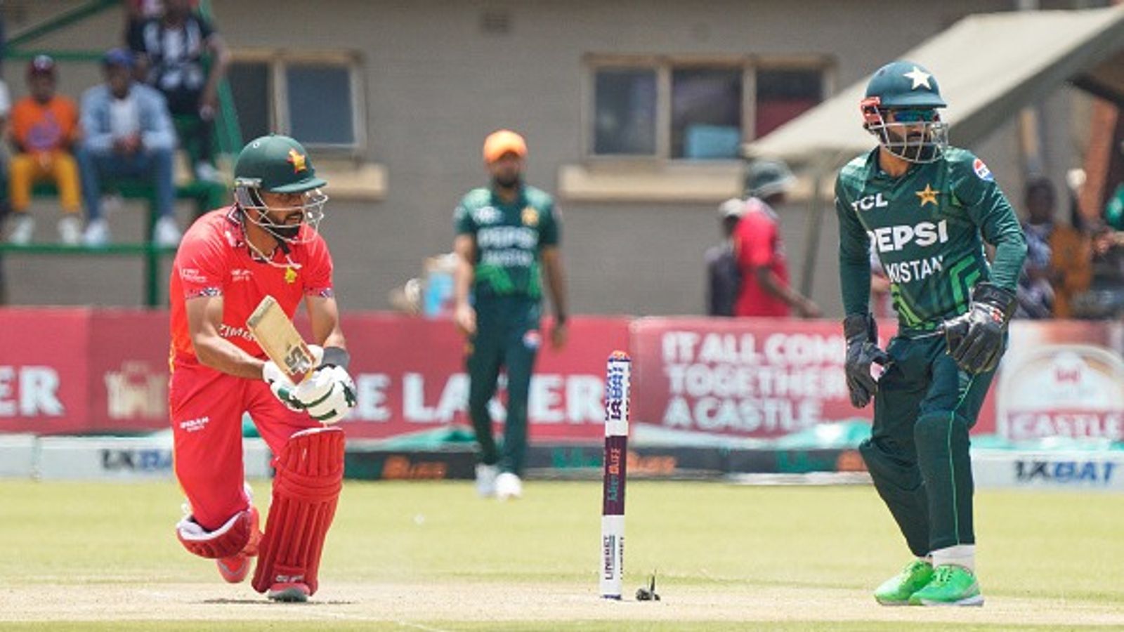 ZIM vs PAK: Zimbabwe shock Pakistan again, upset Mohammad Rizwan's men by 80 runs in 1st ODI after Sikandar Raza's all-round heroics Zimbabwe's Sikandar Raza (L) plays a sweep as Pakistan captain Mohammad Rizwan looks on during first ODI
