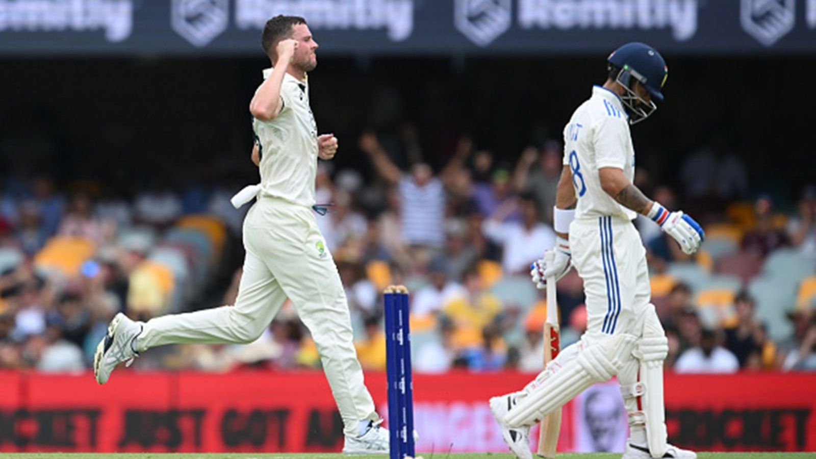 'Virat Kohli should learn from Dhoni and retire': Fans lash out as Virat Kohli loses his wicket chasing after a delivery outside off once again Josh Hazlewood of Australia celebrates the wicket of Virat Kohli of India during day three of the Third Test match in the series between Australia and India at The Gabba on December 16, 2024 in Brisbane.