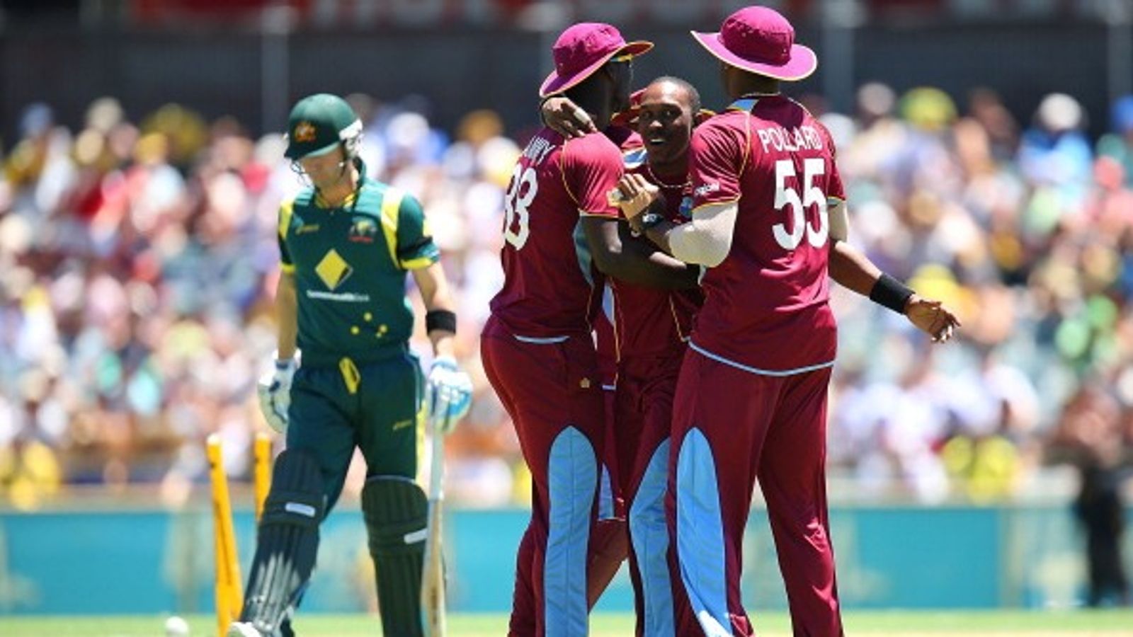 Two-time World Cup winning captain to become West Indies' all format head coach File Photo: West Indies' Dwayne Bravo (C) celebrates with teammates Darren Sammy and Kieron Pollard during an ODI match against Australia