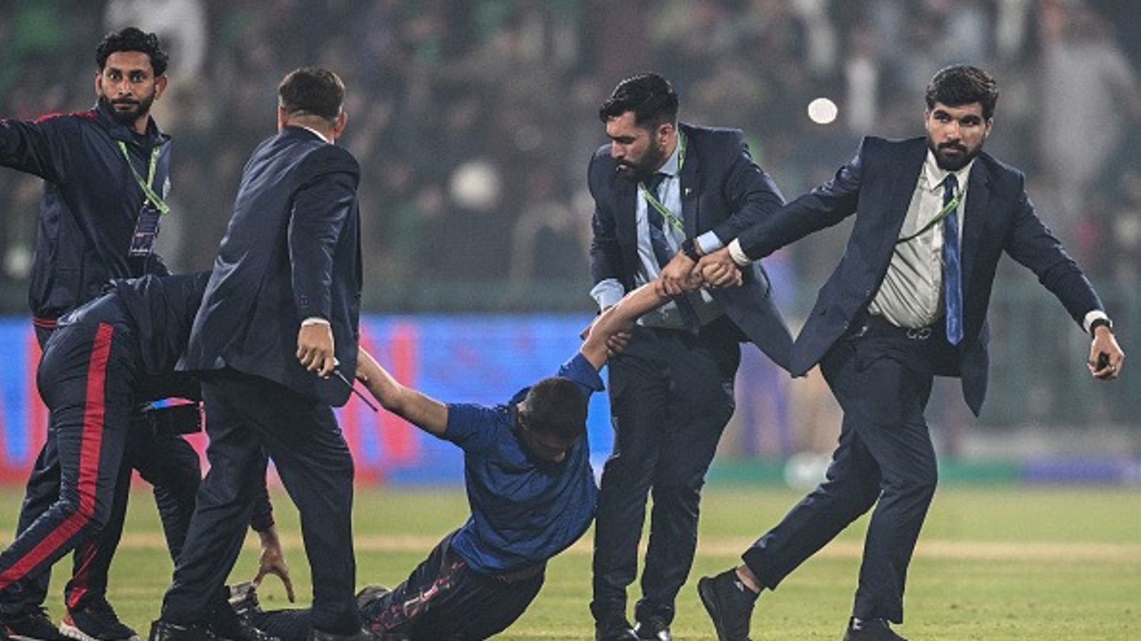 Massive security breach in Lahore, fan storms pitch after Afghanistan’s historic win against England in Champions Trophy Security personnel detain a pitch invader at the end of the ICC Champions Trophy one-day international