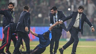 Massive security breach in Lahore, fan storms pitch after Afghanistan’s historic win against England in Champions Trophy  Security personnel detain a pitch invader at the end of the ICC Champions Trophy one-day international