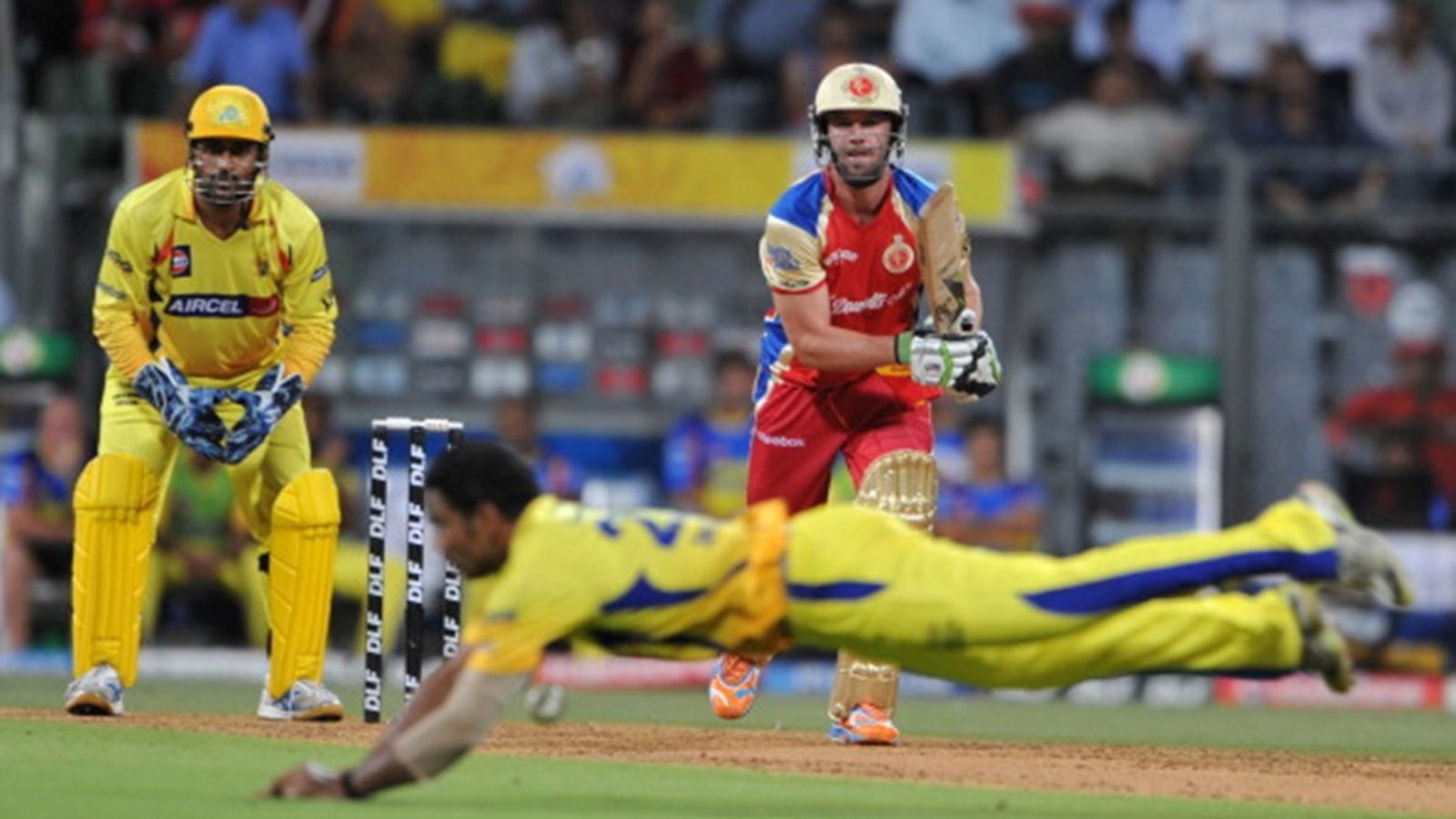 'They would focus on 2-3 players only. There was no camaraderie, players didn't gel properly': CSK's two-time IPL-winner who played one match for RCB RCB batter AB De Villiers (R, rear) plays a shot as CSK bowler Shadab Jakati (front) dives to stop the ball during the IPL qualifier match at The Wankhede Stadium in Mumbai on May 24, 2011.