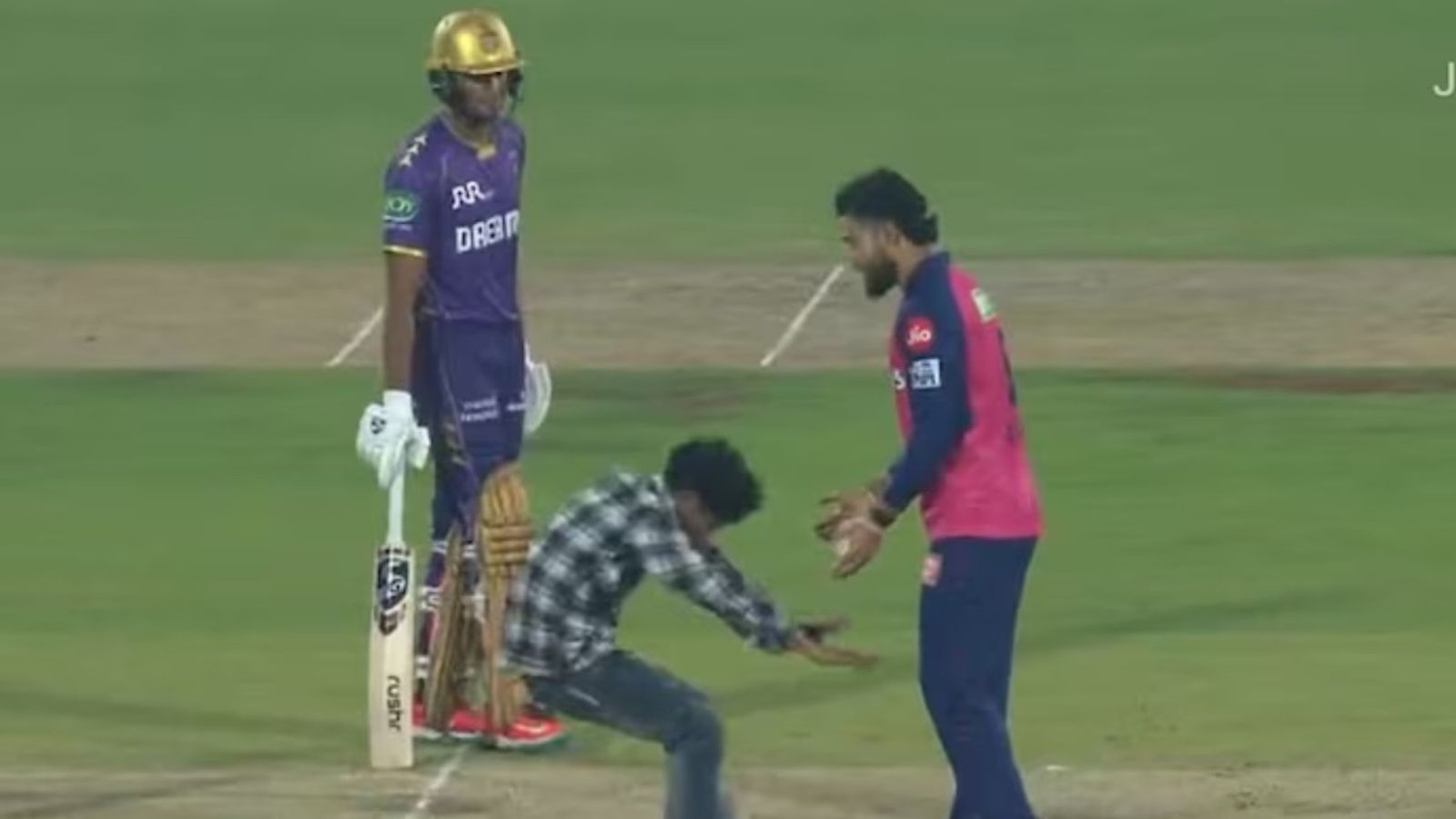 Fan invades Guwahati's pitch and touches Riyan Parag's feet during RR vs KKR IPL 2025 clash Fan invades pitch to touch Ryan Parag's feet