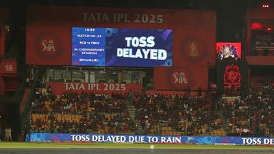 RCB vs PBKS IPL 2025: Toss delayed due to steady drizzle, know the playing conditions and cut-off time in rain-curtailed match Spectators wait as rain delays toss of the RCB vs PBKS IPL 2025 clash at the M Chinnaswamy stadium