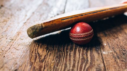 BCCI bans this franchise owner for lifetime in middle of IPL 2025 for match-fixing scandal A cricket bat resting on a red cricket ball on a wooden floor in a old cricket pavilion