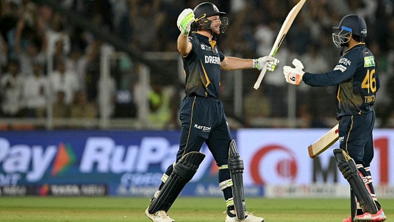 'Told Rahul Tewatia...': GT star Jos Buttler's big revelation after missing out on century against Delhi Capitals Gujarat Titans' Rahul Tewatia (R) embraces Jos Buttler after winning the Indian Premier League (IPL) Twenty20 cricket match against Delhi Capitals at the Narendra Modi Stadium