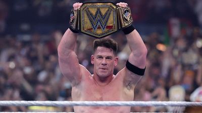 What is the One Title That 17-Time World Champion John Cena Never Won in the WWE? John Cena holds the WWE Championship high at WrestleMania 41.