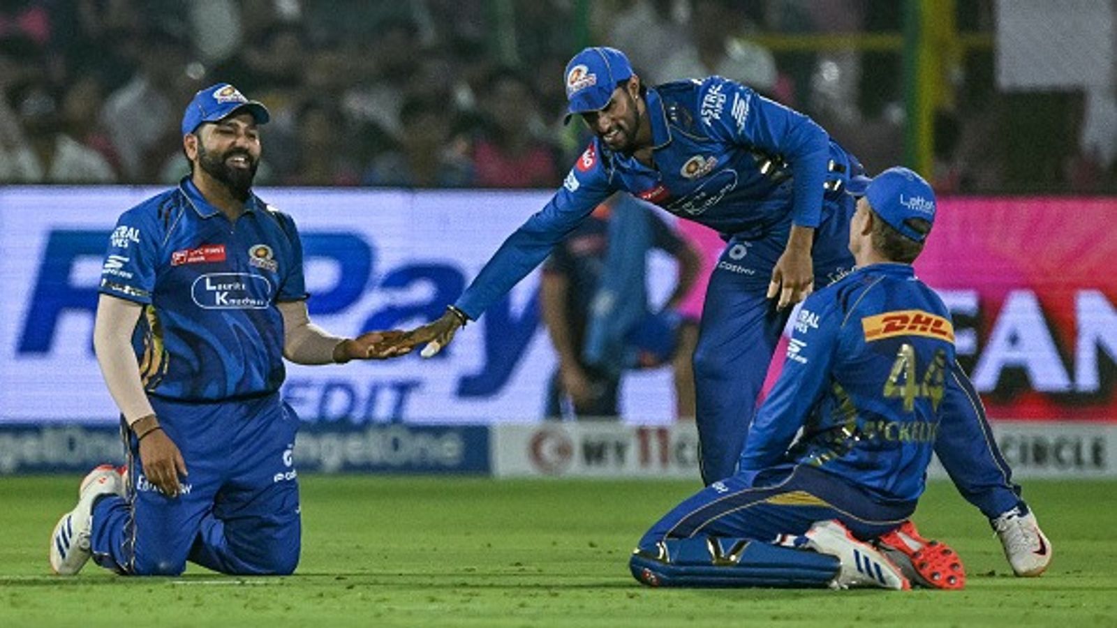 RR vs MI Highlights, IPL 2025: Rajasthan Royals becomes second team to get eliminated from IPL 2025 playoffs after a humiliating 100-run defeat against Mumbai Indians Mumbai Indians' Rohit Sharma (L), Tilak Varma (C) and Ryan Rickelton gesture during the Indian Premier League (IPL) Twenty20 cricket match between Rajasthan Royals and Mumbai Indians