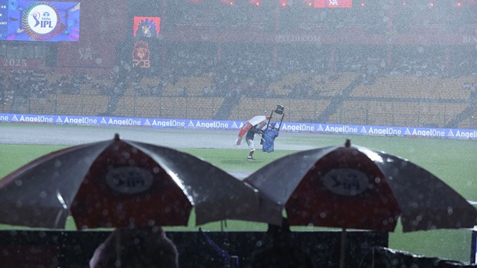 IPL 2025: What is the cut-off time for full 20-over and five-over RCB vs KKR match as persistent rain delays toss in Bengaluru The Spidercam lens is cover by an operative as toss is delayed due to rain prior to the 2025 IPL match between Royal Challengers Bengaluru and Kolkata Knight Riders at M Chinnaswamy Stadium