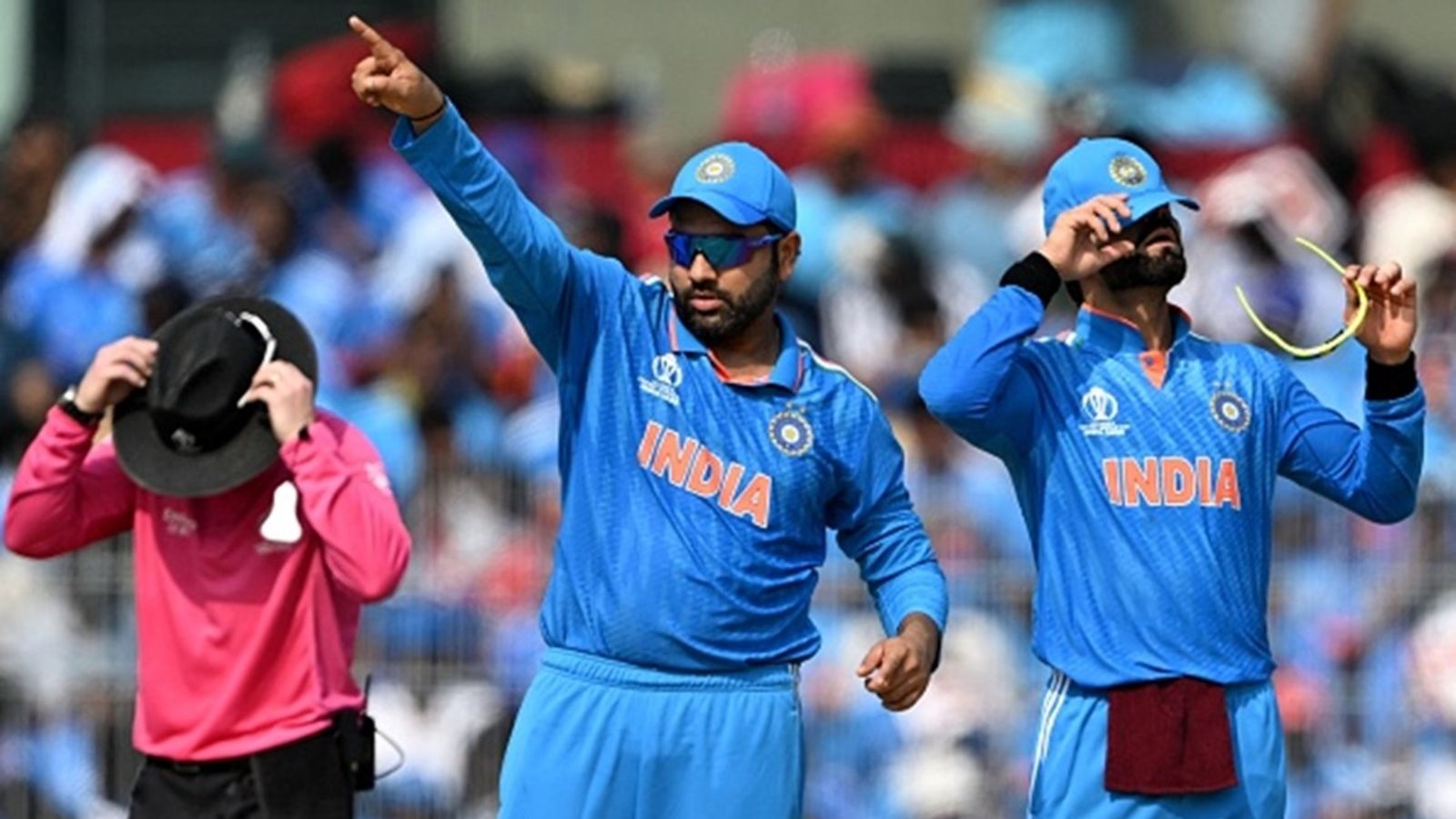 'It's not easy to just do what they need to in terms...': Anil Kumble on Virat Kohli and Rohit Sharma's ODI future India's captain Rohit Sharma (C) and Virat Kohli (R) gesture during the 2023 ICC Men's Cricket World Cup ODI match against Australia at the MA Chidambaram Stadium in Chennai on October 8, 2023.