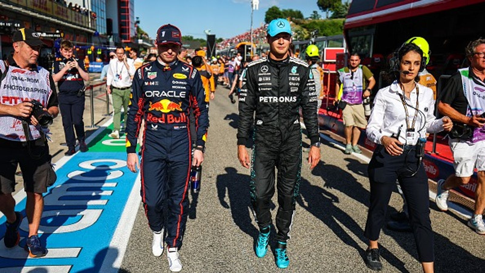 George Russell Makes Scathing Claim After Max Verstappen Collision at Spanish GP, 'It felt very deliberate' Max Verstappen of Netherlands and Oracle Red Bull Racing walks in pit lane with George Russell of Great Britain