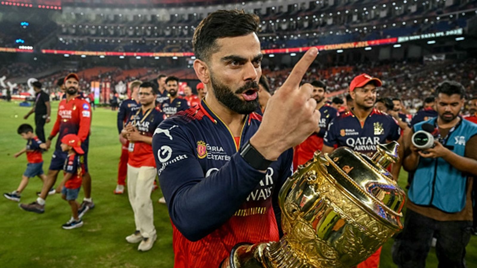 'You've made me wait 18 years to be able to lift you and...': Virat Kohli's jubilation-filled first Instagram post upon winning IPL 2025 final goes viral RCB's Virat Kohli (C), along with his teammates, takes a victory lap around the field as he celebrates with the trophy after winning the IPL final against PBKS at the Narendra Modi Stadium in Ahmedabad on June 4.