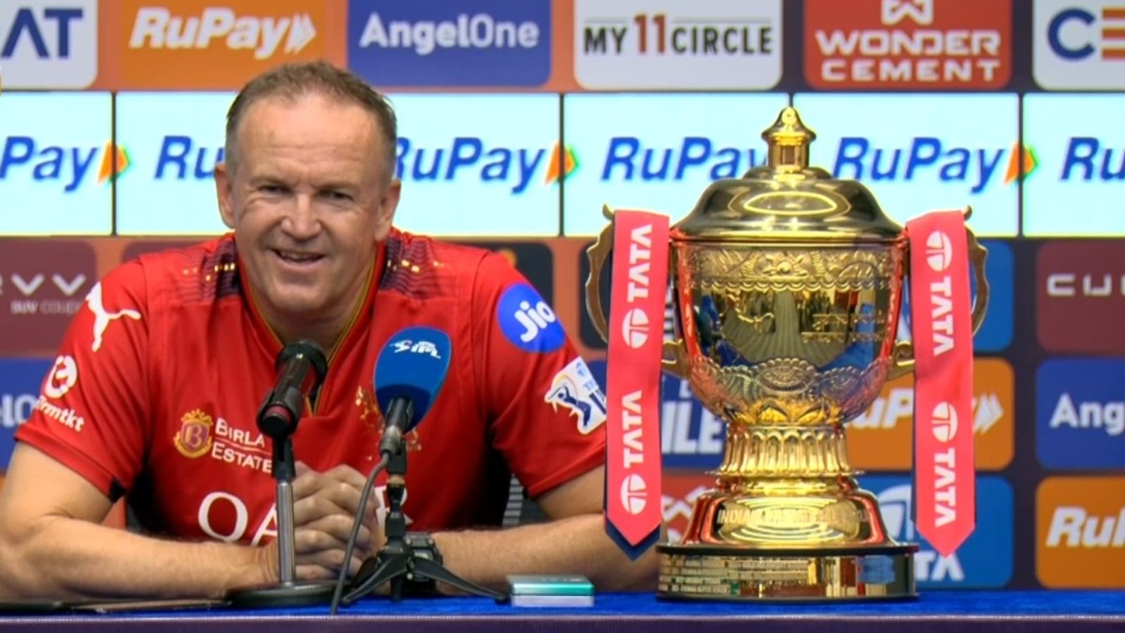 'People thought that we were investing our money rather than spending it. But...': RCB head coach Andy Flower lays bare much-criticised strategy RCB head coach Andy Flower with the IPL 2025 trophy in the post-match press conference.