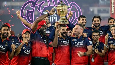 'Why do I need RCB? I don't even drink Royal Challenge...': Karnataka Deputy CM's epic response on rumours of buying franchise goes viral Virat Kohli (C), along with his former teammates AB de Villiers (centre R) and Chris Gayle (centre L), celebrates with the trophy after winning the Indian Premier League (IPL) Twenty20 final cricket match against Punjab Kings
