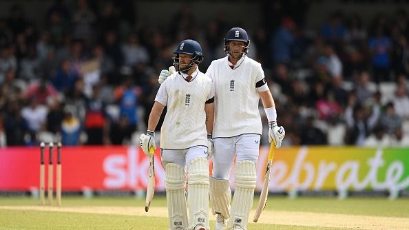 England's Ben Duckett (L) and Joe Root in frame