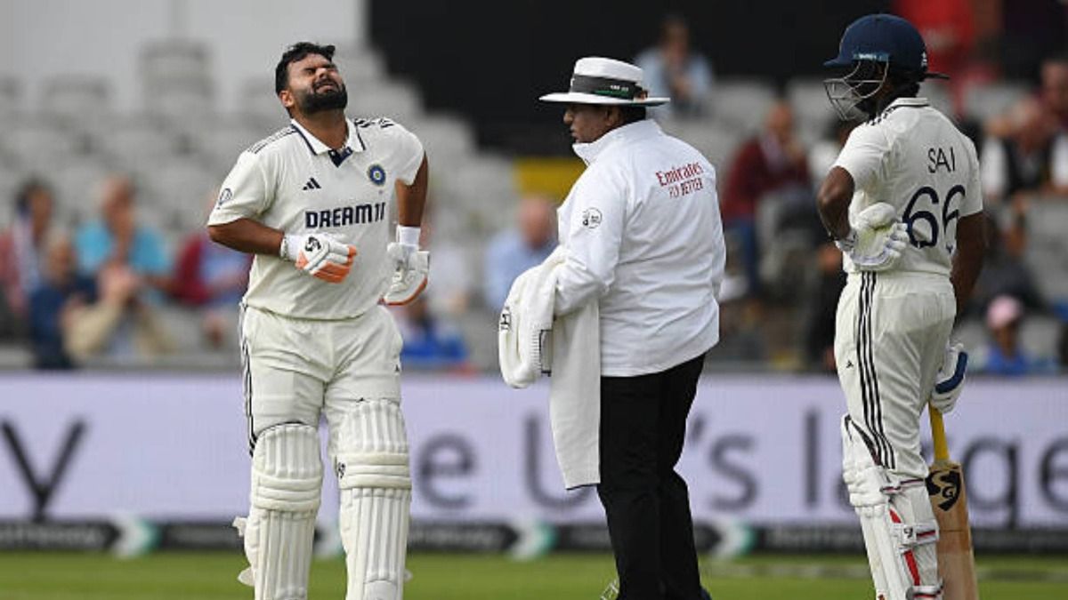 Rishabh Pant (L) of India before leaving the field in an ambulance vehicle during the first day of the 4th Rothesay Test match between England and India at Emirates Old Trafford