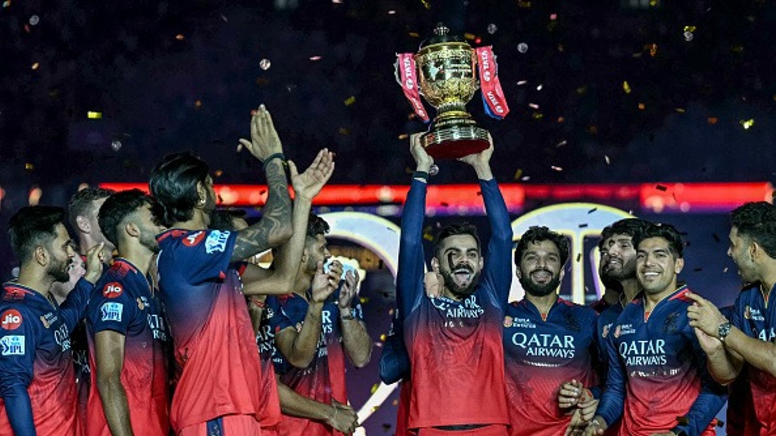 'Giving water is a good thing..World’s number one Virat Kohli...': RCB youngster slams netizens for trolling him over not getting to play in IPL 2025 Royal Challengers Bengaluru's Virat Kohli (C), along with his teammates, celebrates with the trophy after winning the Indian Premier League (IPL) Twenty20 final cricket match against Punjab Kings at the Narendra Modi Stadium