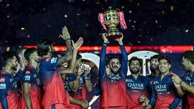 Royal Challengers Bengaluru's Virat Kohli (C), along with his teammates, celebrates with the trophy after winning the Indian Premier League (IPL) Twenty20 final cricket match against Punjab Kings at the Narendra Modi Stadium Royal Challengers Bengaluru's Virat Kohli (C), along with his teammates, celebrates with the trophy after winning the Indian Premier League (IPL) Twenty20 final cricket match against Punjab Kings at the Narendra Modi Stadium