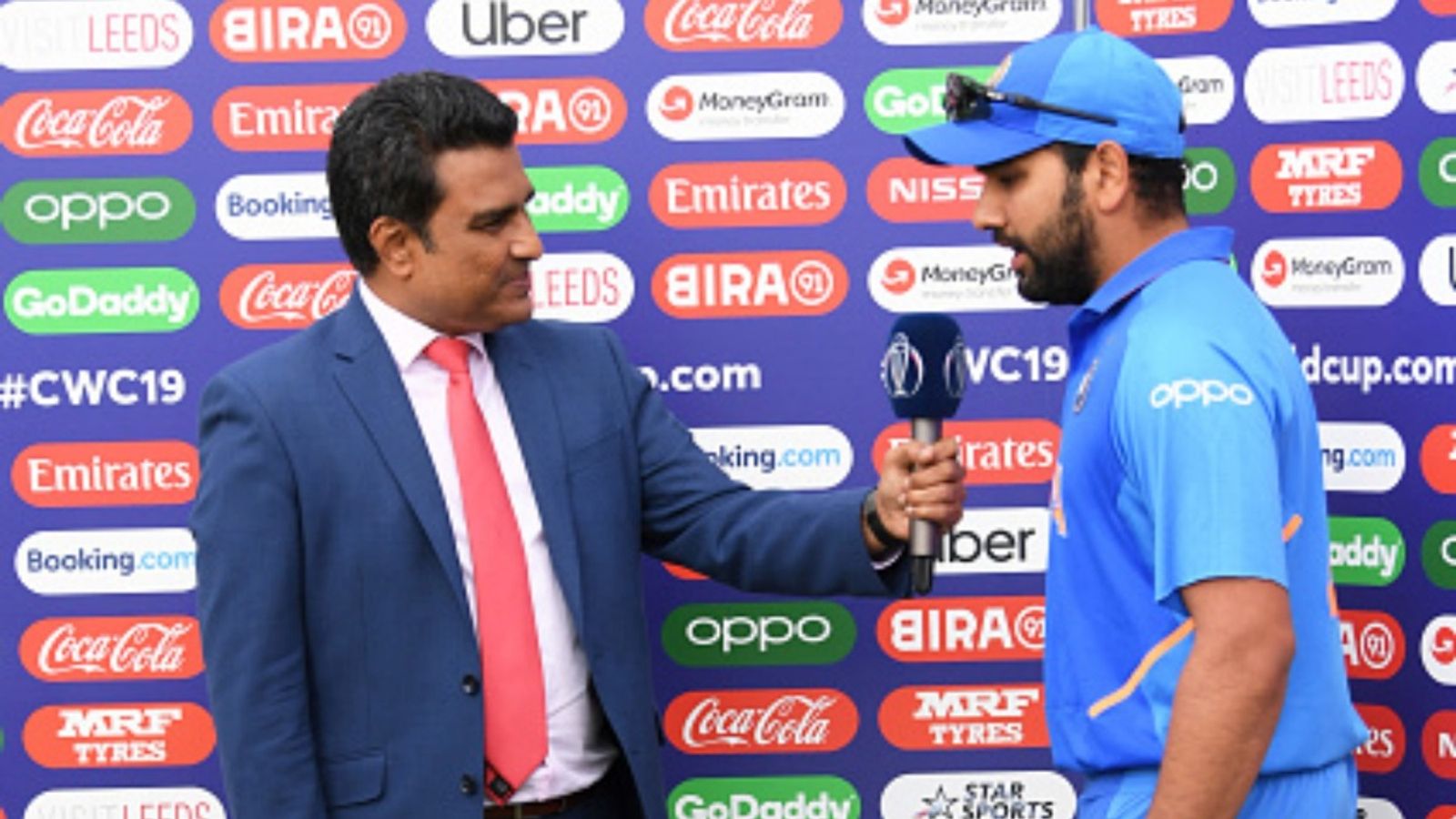 'Rohit Sharma doesn't fit in All Time Indian Batting Great list because...': Sanjay Manjrekar makes controversial call despite stellar record ICC Commentator Sanjay Manjrekar interviews Rohit Sharma of India during the Group Stage match of the ICC Cricket World Cup 2019 between Sri Lanka and India at Headingley on July 06, 2019 in Leeds, England.