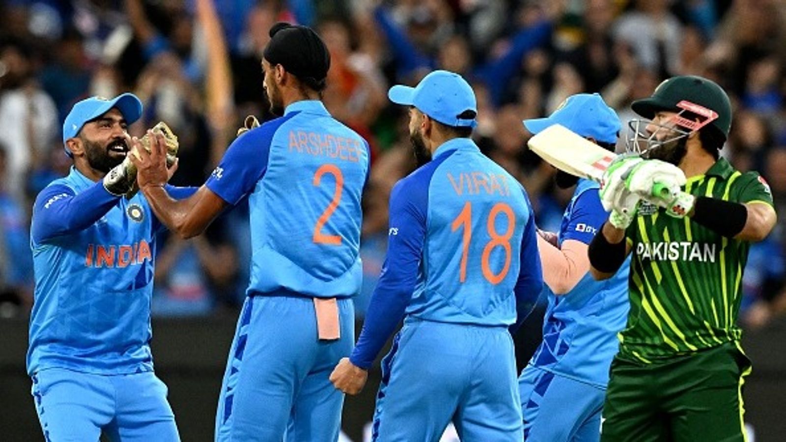 Kapil Dev advises Suryakumar Yadav-led India to 'concentrate only on their performance' against Pakistan in Asia Cup 2025 amid boycott calls over Pahalgam attack Dinesh Karthik (L) greets India's Arshdeep Singh (2nd L) as Pakistan's Mohammad Rizwan (R) walks off the field after his dismissal during the ICC men's Twenty20 World Cup 2022 cricket match between India and Pakistan at Melbourne Cricket Ground (MCG)