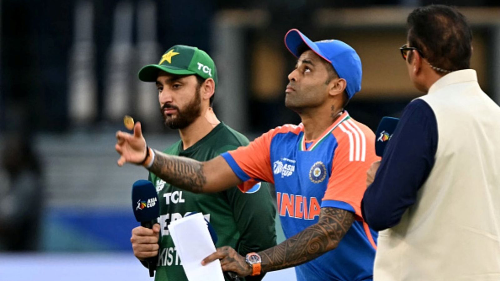 Will Suryakumar Yadav be sanctioned for Pahalgam statement and refusing customary handshake? Big update clarifies India's captain Suryakumar Yadav (C) tosses the coin at the start of the Asia Cup 2025 Twenty20 match against Pakistan at the Dubai International Stadium in Dubai on September 14, 2025.