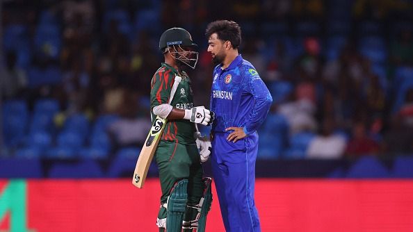 Litton Das of Bangladesh and Rashid Khan of Afghanistan interact between wicketsduring the ICC Men's T20 Cricket World Cup West Indies & USA 2024 Super Eight match between Afghanistan and Bangladesh