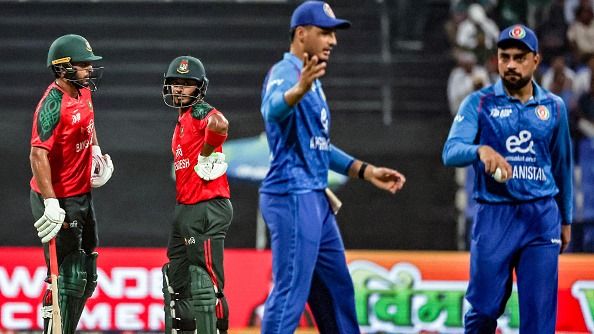 Bangladesh's Saif Hassan (L) speaks with Tanzid Hasan (2L) as Afghanistan's captain Rashid Khan (R) looks on during the Asia Cup 2025 Twenty20 international cricket match between Afghanistan and Bangladesh at the Sheikh Zayed Cricket Stadium in Abu Dhabi