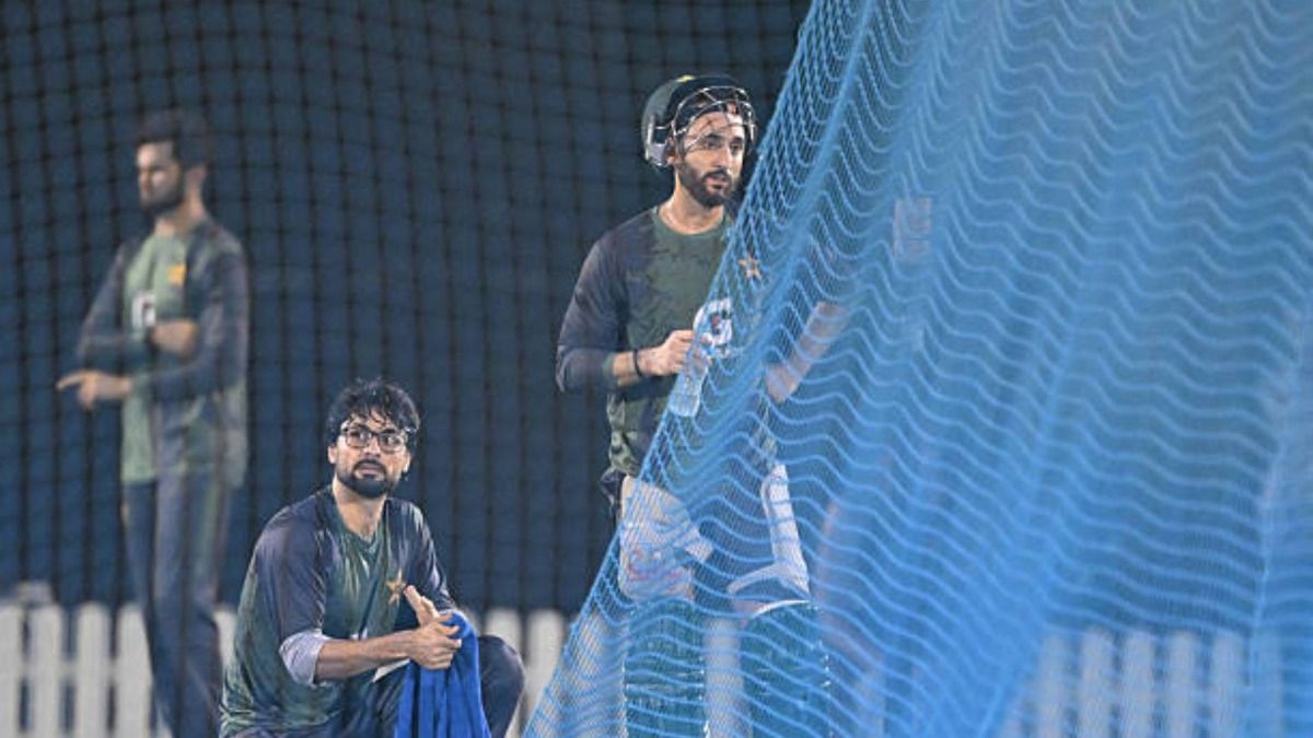 Pakistan's captain Salman Agha (R) and teammate Abrar Ahmed (L) attend a practice session at the International Cricket Council (ICC) Academy in Dubai on September 16, 2025