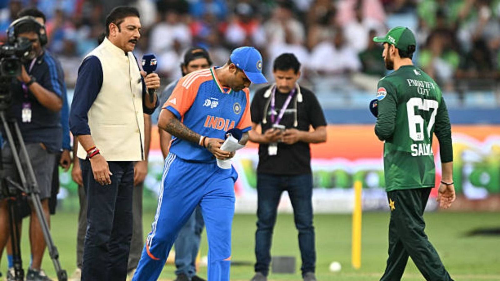 IND vs PAK: Suryakumar Yadav shows Pakistan their place again, refuses to shake hands with Salman Ali Agha at toss India's captain Suryakumar Yadav (C) walks after the toss as his Pakistan's counterpart Salman Agha (R) watches before the start of the Asia Cup 2025 Super Four Twenty20 international cricket match between India and Pakistan