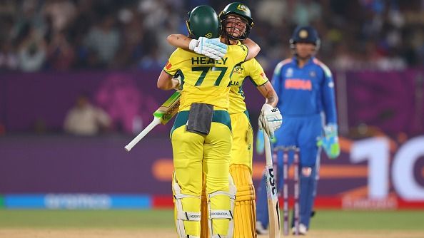 Australia's Alyssa Healy (L) is congratulated by her teammate Ash Gardner after belting a ton against India