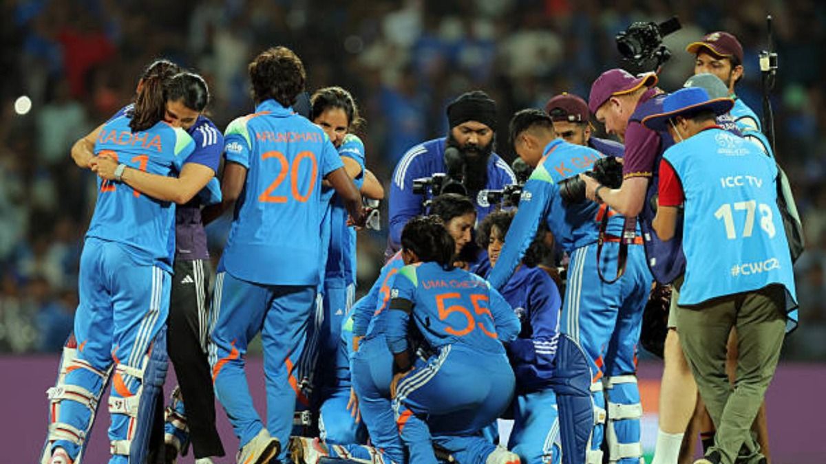 Jemimah Rodrigues and Amanjot Kaur of India celebrate with team mates following victory in the ICC Women's Cricket World Cup India 2025 Semi-Final match between India and Australia