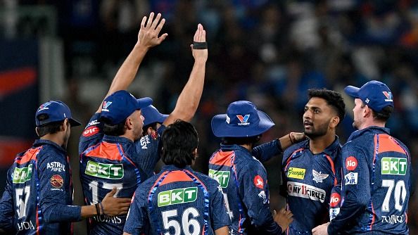 Lucknow Super Giants' Mohsin Khan (2R) and Marcus Stoinis (2L) celebrate with teammates after taking the wicket 