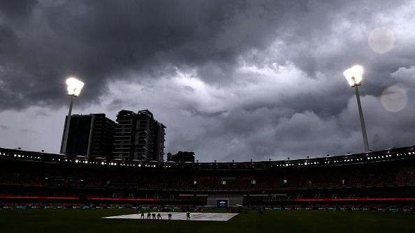 Ground staff cover the pitch as storm clouds approach during a rain delay on day five of the third cricket Test match between Australia and India at The Gabba in Brisbane Ground staff cover the pitch as storm clouds approach during a rain delay on day five of the third cricket Test match between Australia and India at The Gabba in Brisbane
