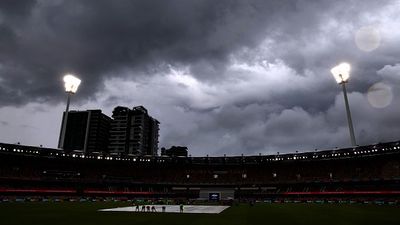 India vs Australia 5th T20I weather forecast: Rain likely to play spoilsport at Gabba in series decider Ground staff cover the pitch as storm clouds approach during a rain delay on day five of the third cricket Test match between Australia and India at The Gabba in Brisbane