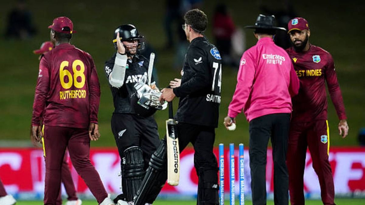 Tom Latham (L) and Mitchell Santner of New Zealand celebrate the wicket of during the second One Day International match in the series between New Zealand and West Indies at McLean Park