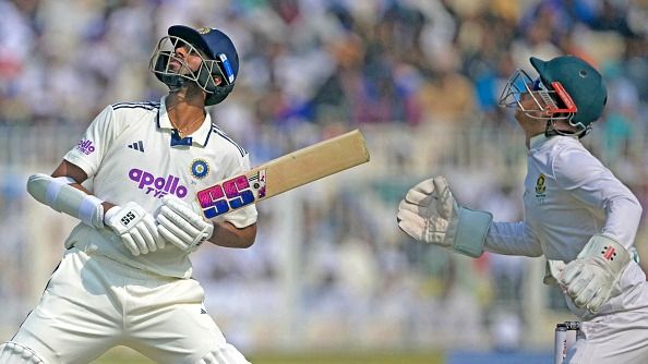 Kyle Verreynne (R) looks on as India's Washington Sundar watches the ball after playing a shot 