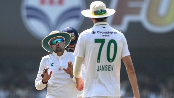 South Africa's Keshav Maharaj (L) speaks with teammate Marco Jansen during the third day of the second Test cricket match between India and South Africa at the Barsapara Cricket Stadium in Guwahati 