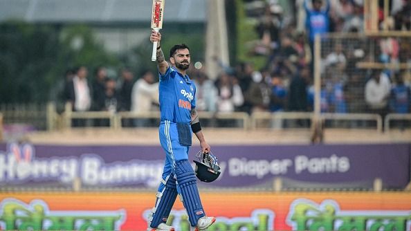 Virat Kohli celebrates after scoring a century (100 runs) during the first one-day international (ODI) cricket match between India and South Africa at the JSCA International Stadium