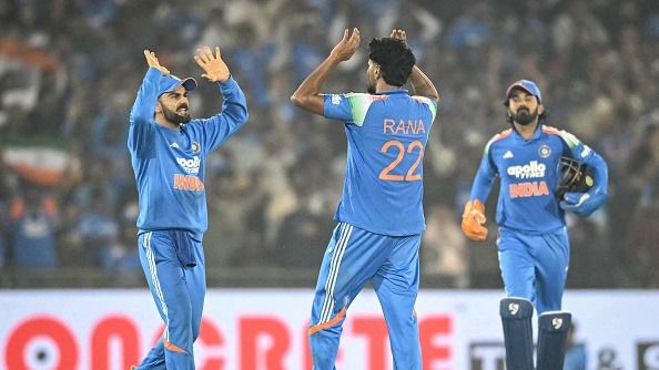 Virat Kohli and Harshit Rana celebrating a wicket and KL Rahul behind them.