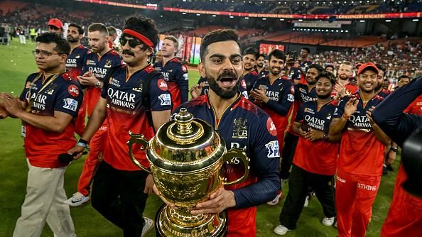 Virat Kohli lifting the Indian Premier League (IPL) trophy after clinching their maiden title