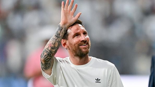 Argentine footballer Lionel Messi waves to the fans in the stands at Wankhede Stadium during the Lionel Messi G.O.A.T Tour on December 14, 2025 in Mumbai, India.