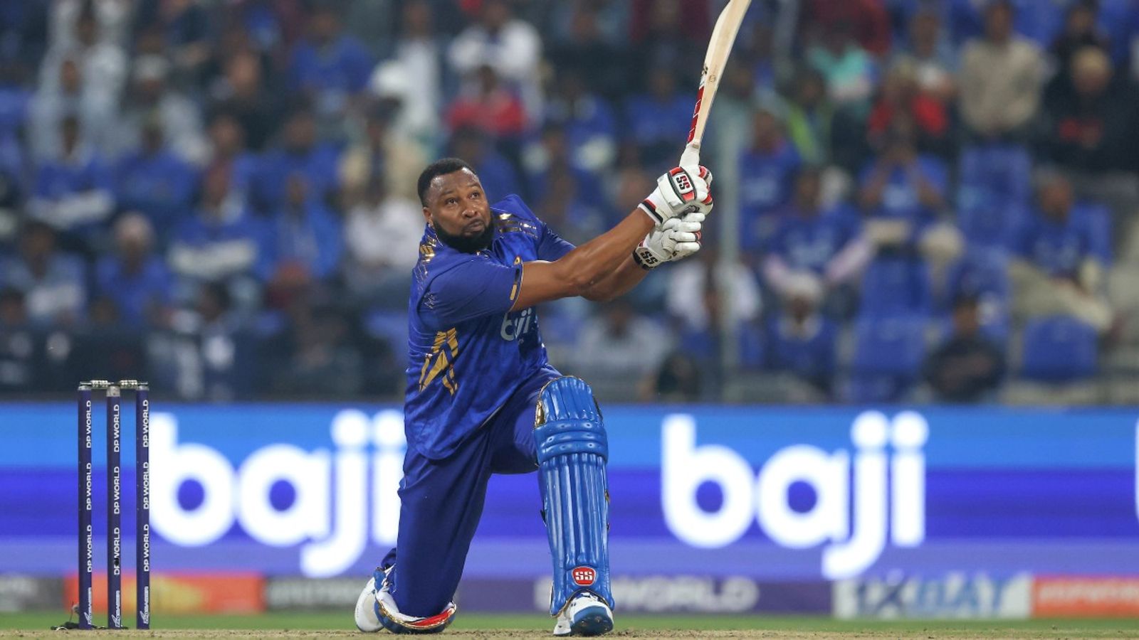 Pollard scores 30 in an over off Afghan spinner, leads MI Emirates to 8-wicket win over Capitals MI Emirates captain Kieron Pollard plays a shot during the match against Dubai Capitals on December 27.