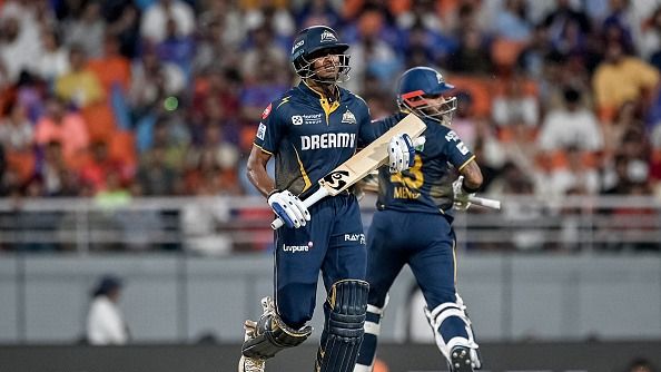 Gujarat Titans' Sai Sudharsan (L) and Kusal Mendis run between the wickets during the Indian Premier League (IPL) Twenty20 Eliminator cricket match between Gujarat Titans and Mumbai Indians