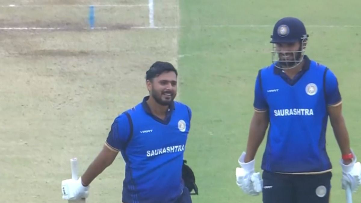 Harvik Desai celebrating his century against UP